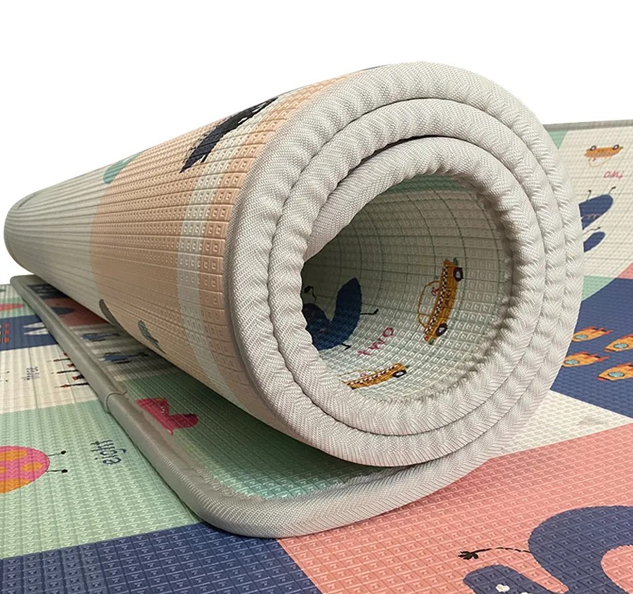 Close-up of a rolled XPE play mat showing its textured surface and bound edge